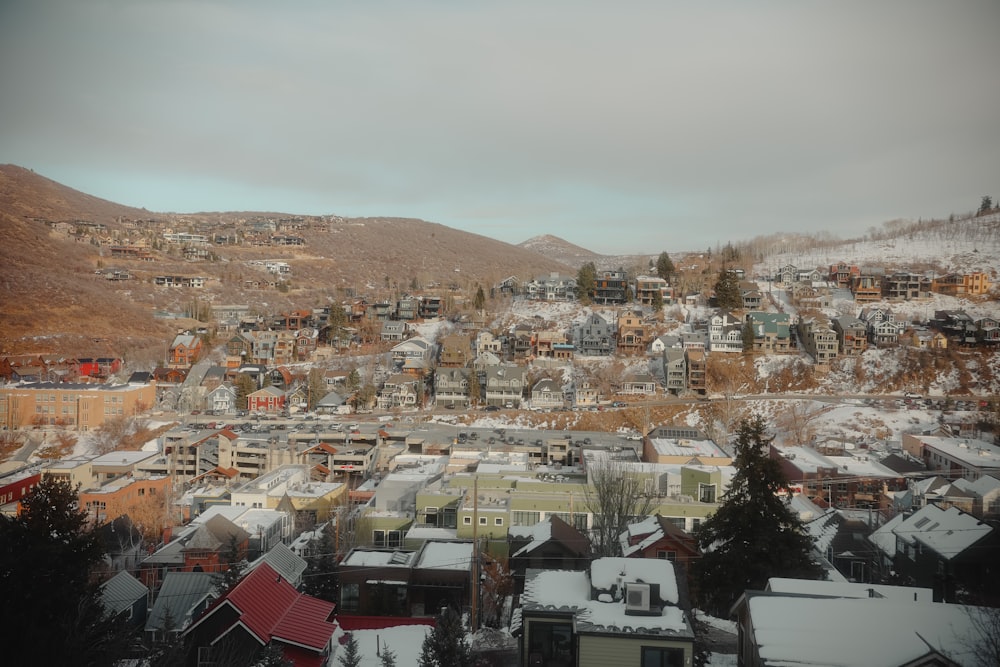 a view of a city in the mountains covered in snow