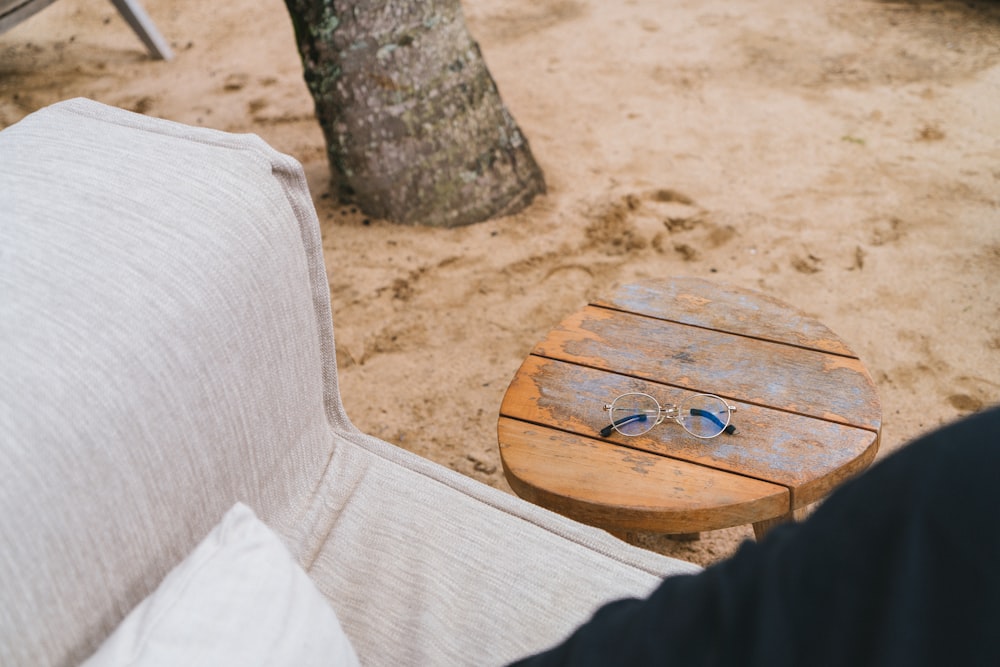 a wooden table sitting on top of a white couch