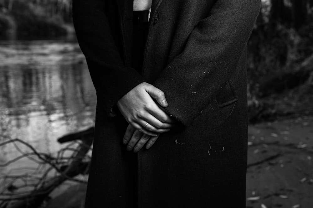 a black and white photo of a man in a coat