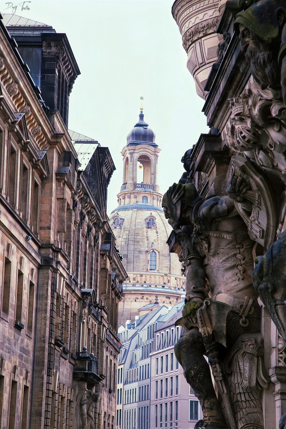 a clock tower towering over a city filled with tall buildings