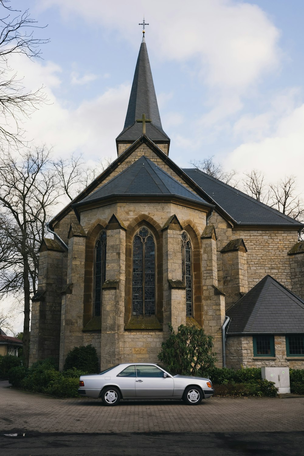 a white car parked in front of a church