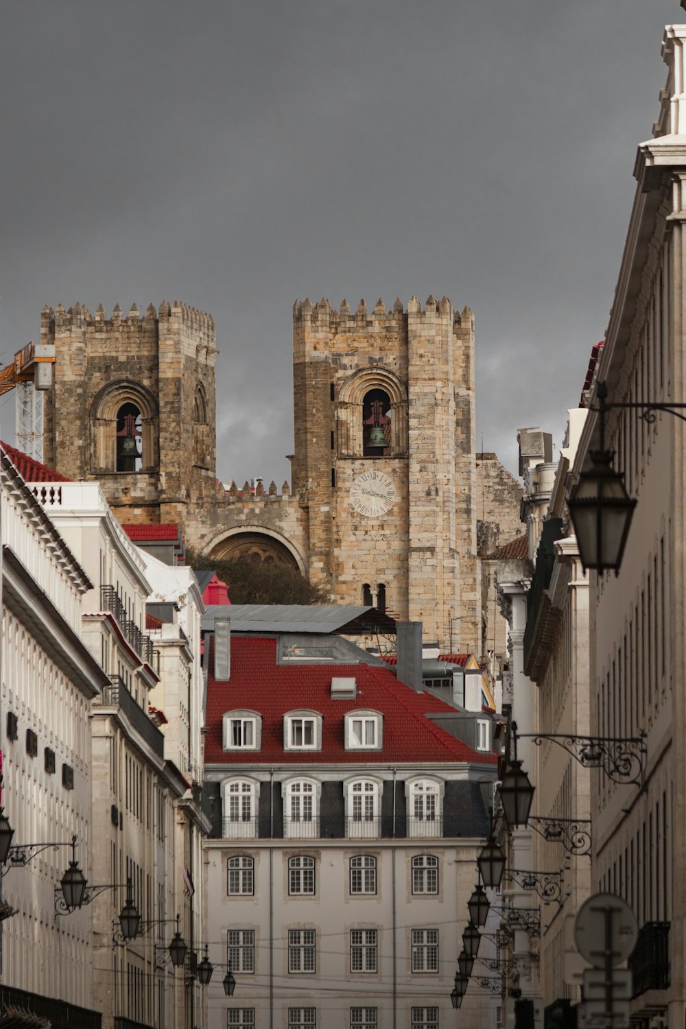 a city street with buildings and a clock tower in the background