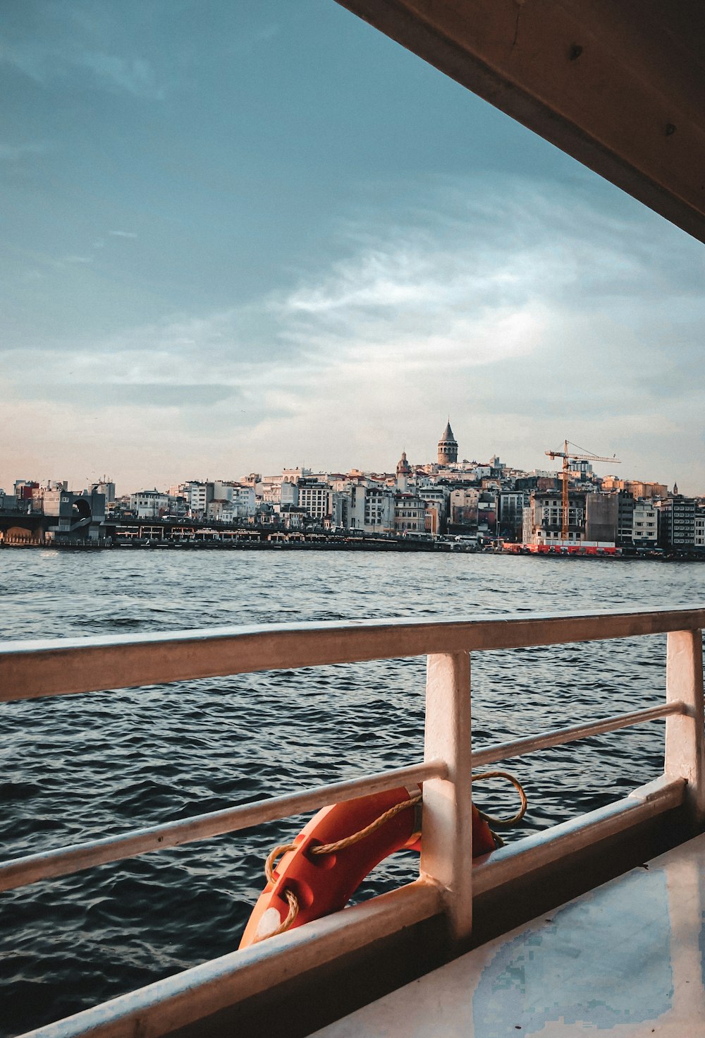 a person sitting on a boat looking out over the water