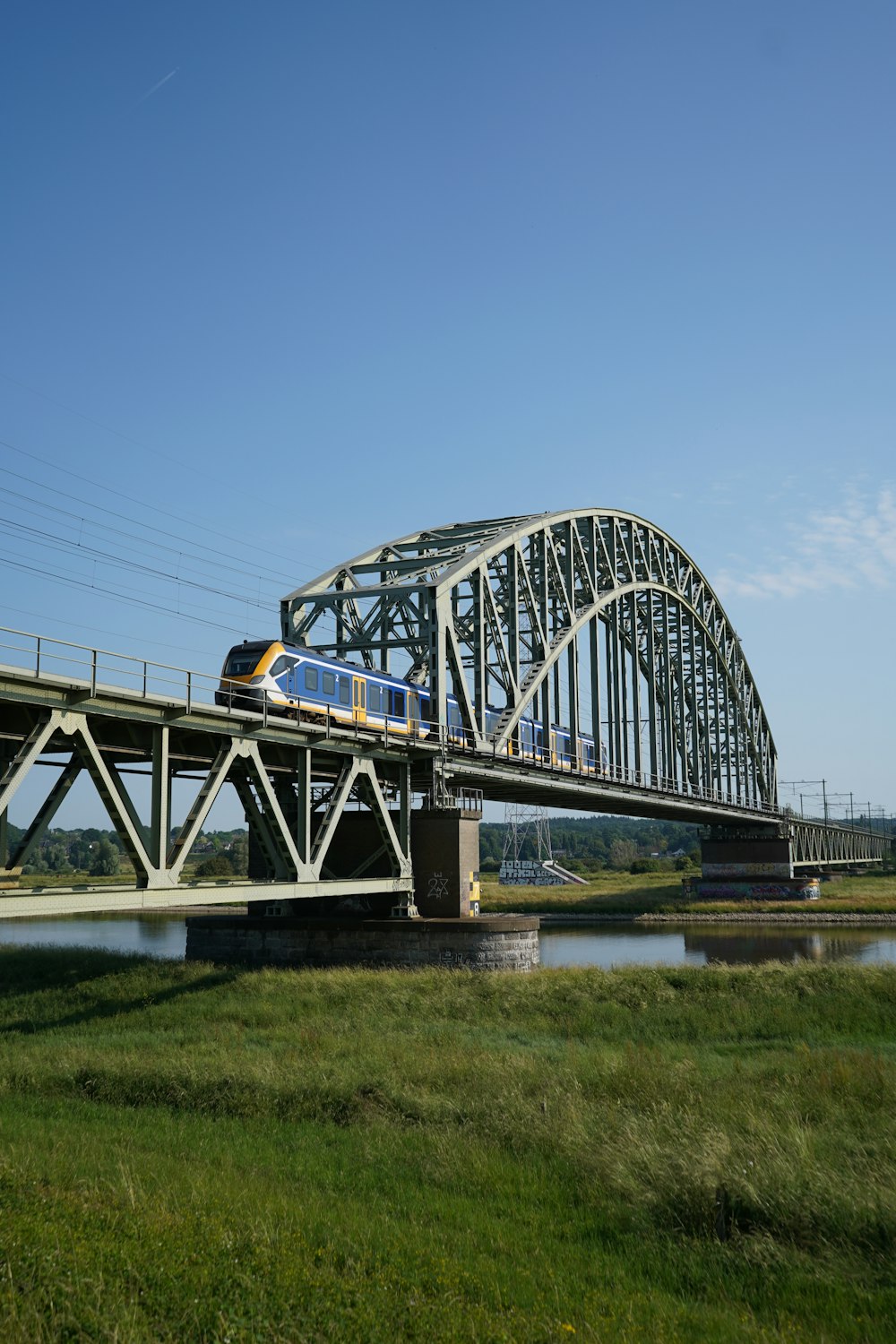 a train crossing a bridge over a body of water