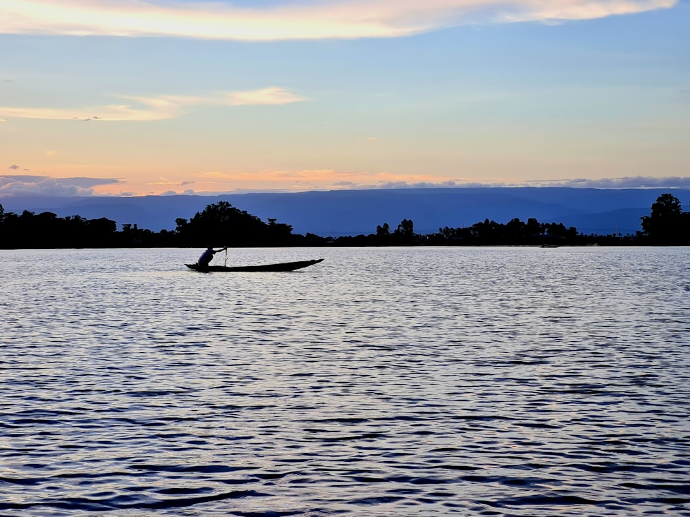 a person in a boat on a large body of water