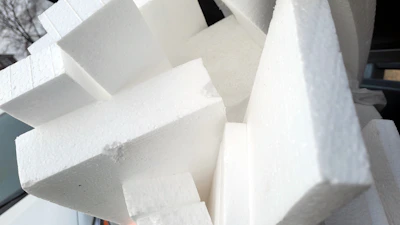 Stacks of white polystyrene blocks ready for wholesale distribution in a Delhi warehouse.