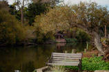 A serene outdoor scene with a notebook and pen resting on a wooden bench