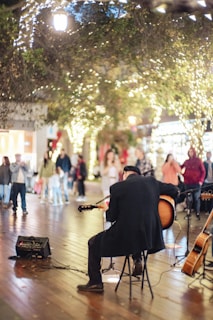 Guests enjoying a musical performance under twinkling lights.
