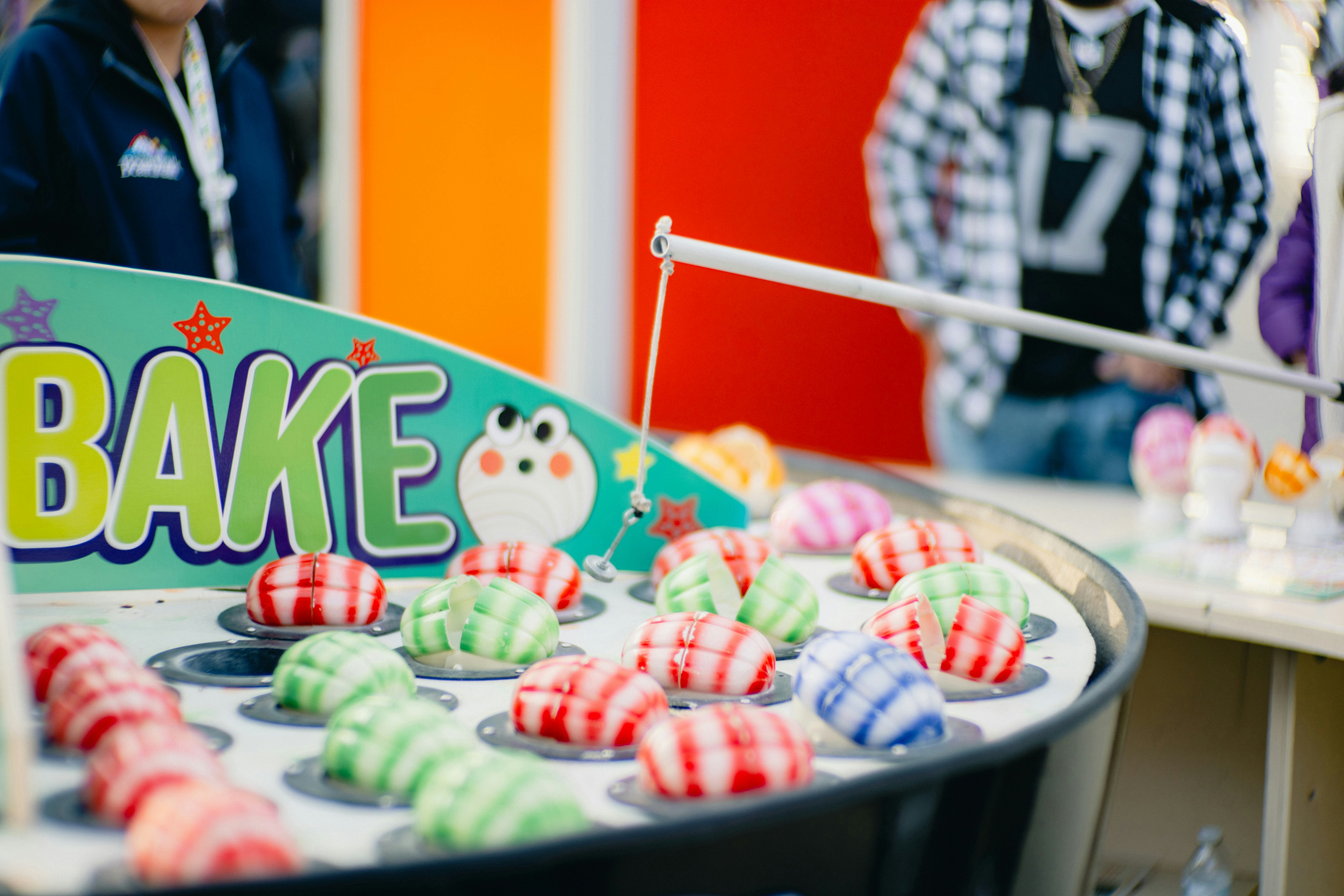 a group of people standing in front of a bake sale sign