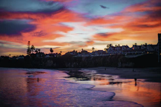 A vibrant beach scene at a famous Mexican coastline during sunset.