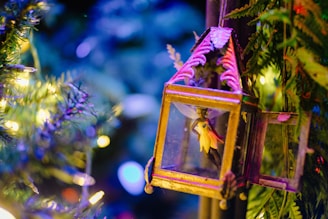 A tiny magical painting of a glowing lantern hanging from a twisted tree branch at dusk.