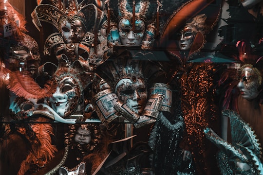 Colorful handcrafted masks inspired by Barranquilla's carnival symbols displayed on a wooden table.