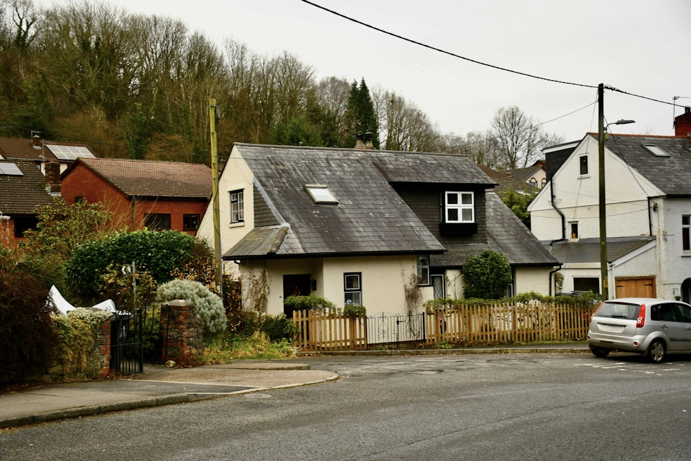 a car parked on the side of a road next to houses