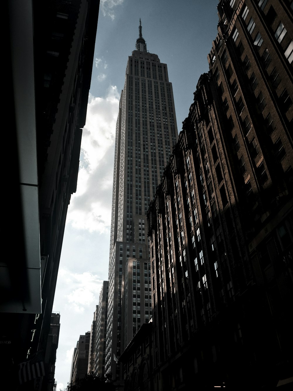 a tall building towering over a city filled with tall buildings