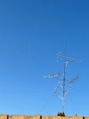 Outdoor radio link antenna mounted on a rooftop against a clear sky.