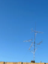 A telemetry system setup with antennas and control units against a clear blue sky.
