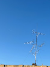 Technician installing a digital radio relay system on a rooftop.