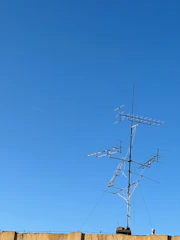 Close-up of a well-installed lightning protection system with clear sky background.