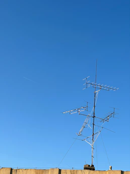 A telemetry system setup with antennas and control units against a clear blue sky.
