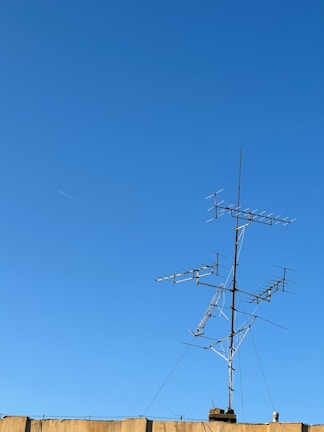 Outdoor radio link antenna mounted on a rooftop against a clear sky.