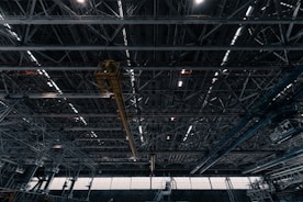 Industrial warehouse structure with steel framework and cranes