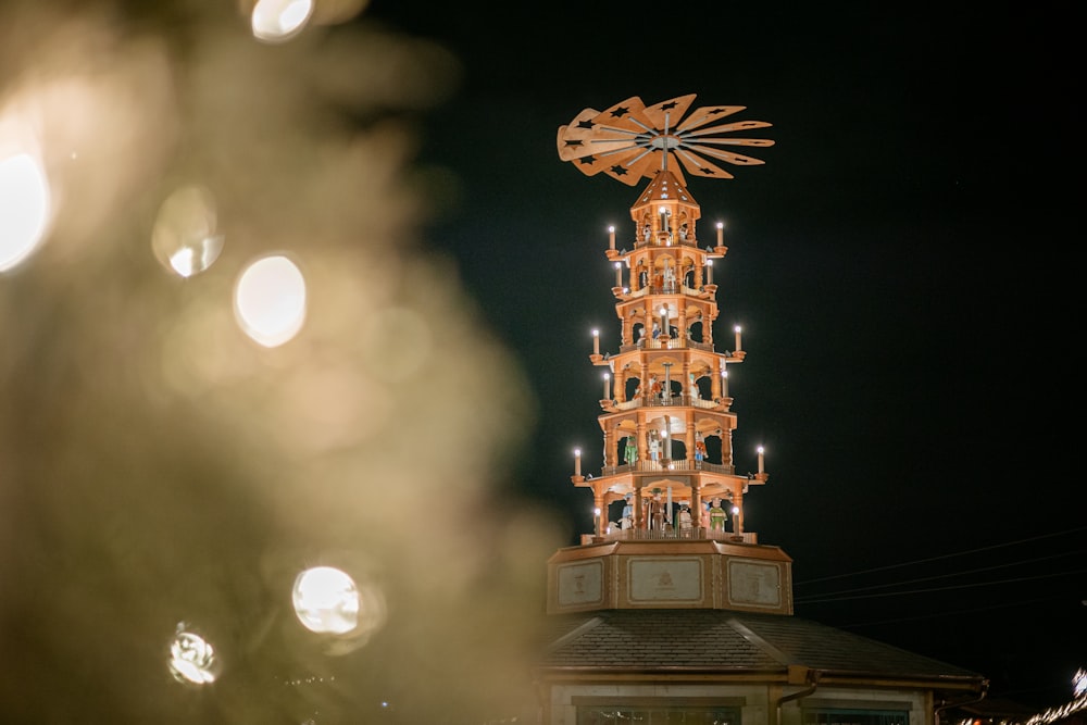 a tall clock tower with lights on top of it