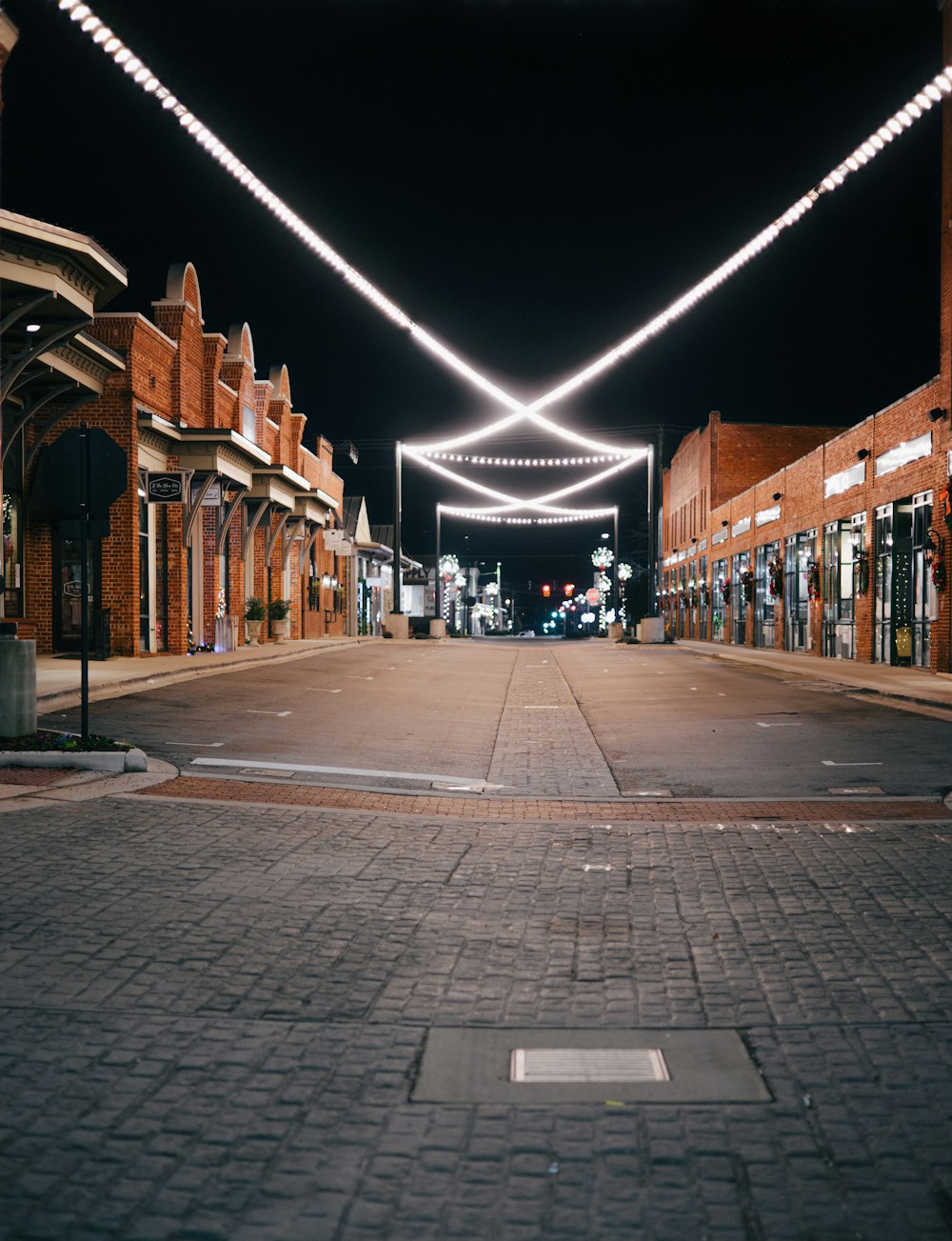 a city street with lights strung over it