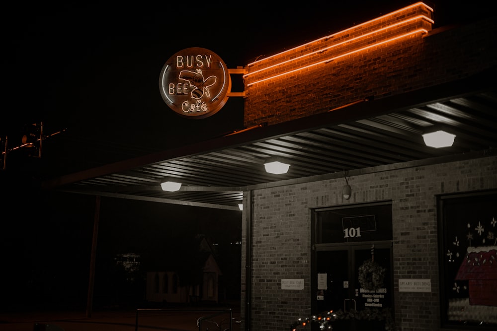 a building with a neon sign above it at night