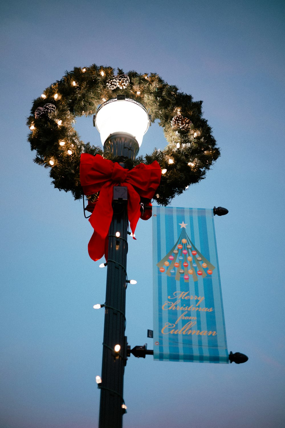 a street light with a wreath on top of it