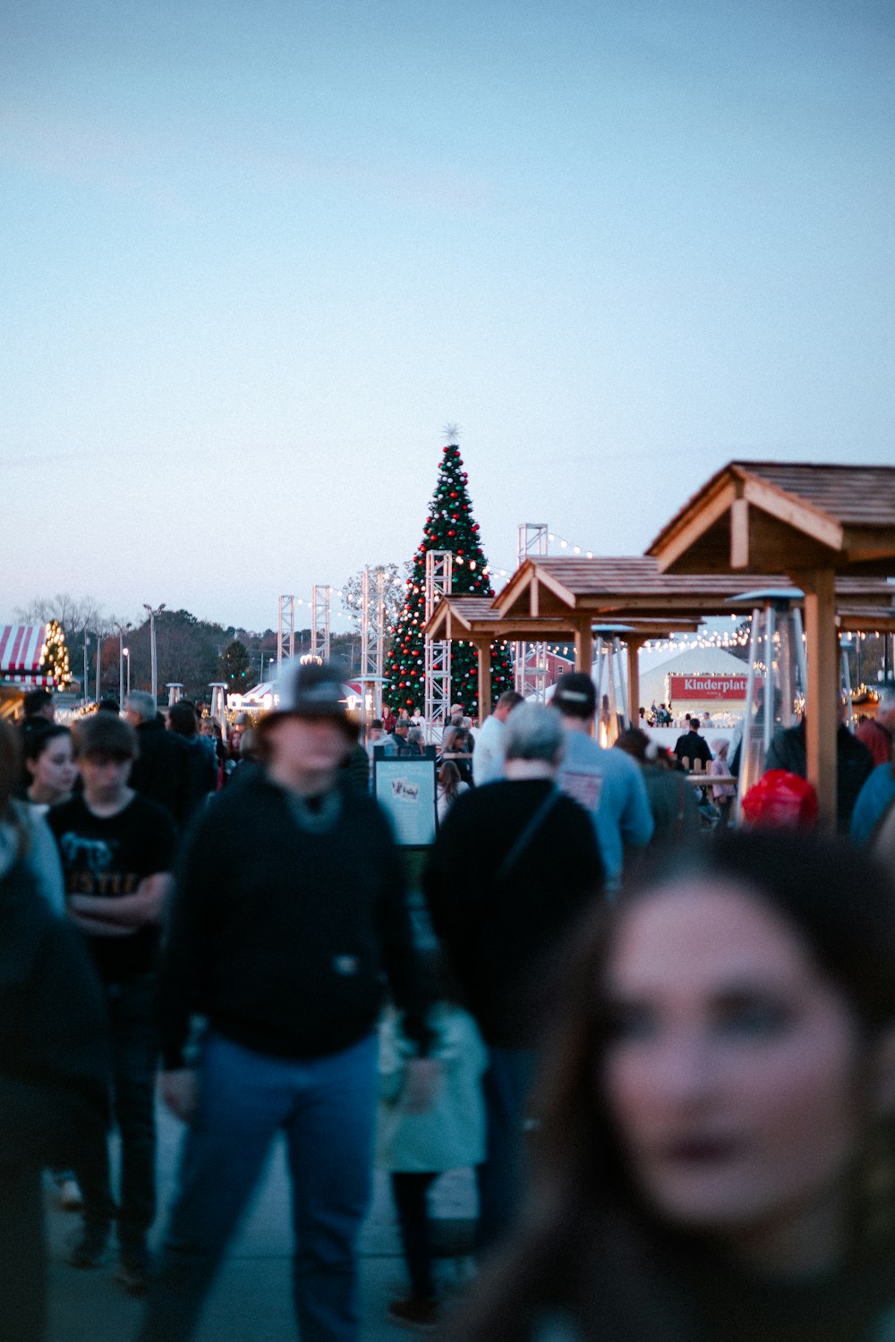 a crowd of people walking around a carnival