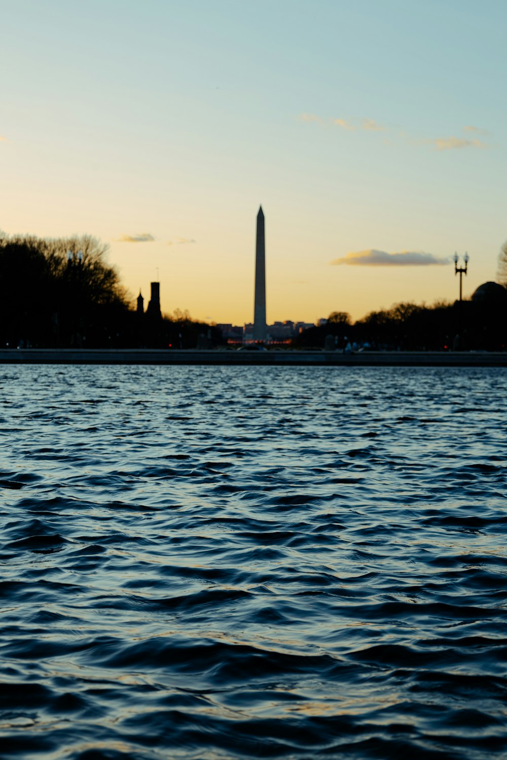 a large body of water with a tower in the background