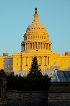 An exterior shot of Capitol Hill bathed in morning sunlight, symbolizing legislative work.