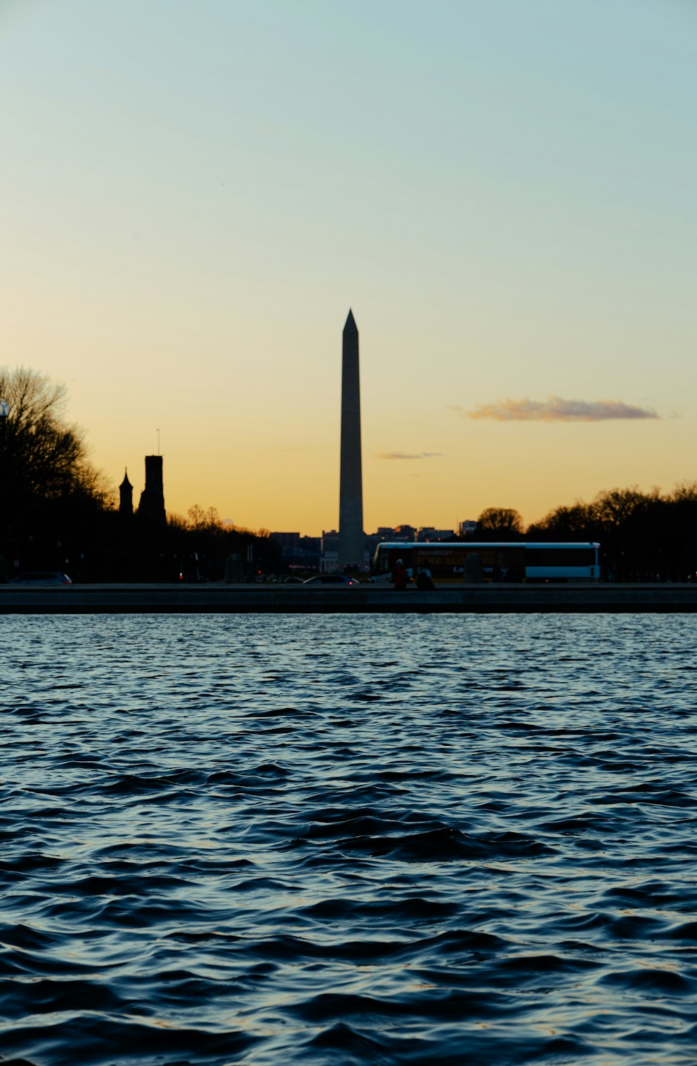 a large body of water near a tall building