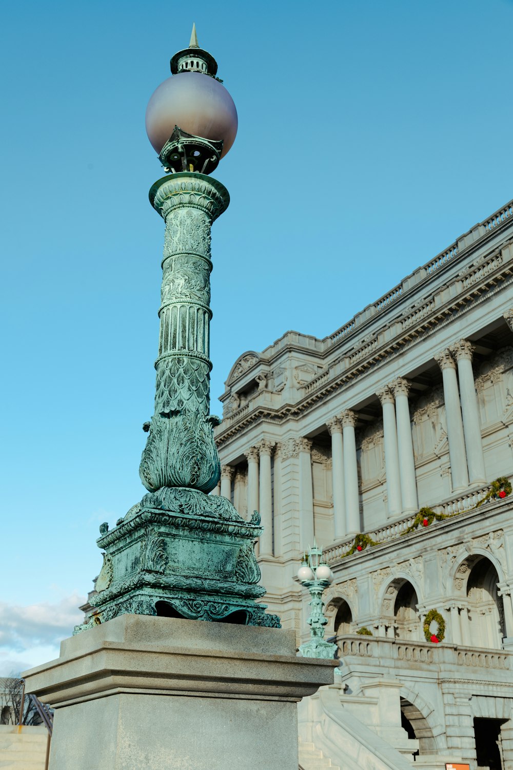 a statue of a woman on a pedestal in front of a building