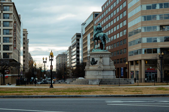 a statue of a man riding a horse in a city