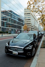 Fleet of premium executive cars lined up on a city street during daytime.