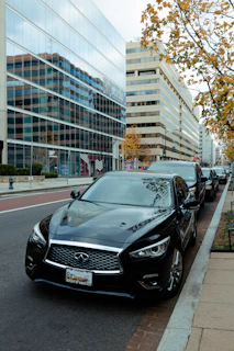 A fleet of well-maintained cars lined up on a city street ready for service
