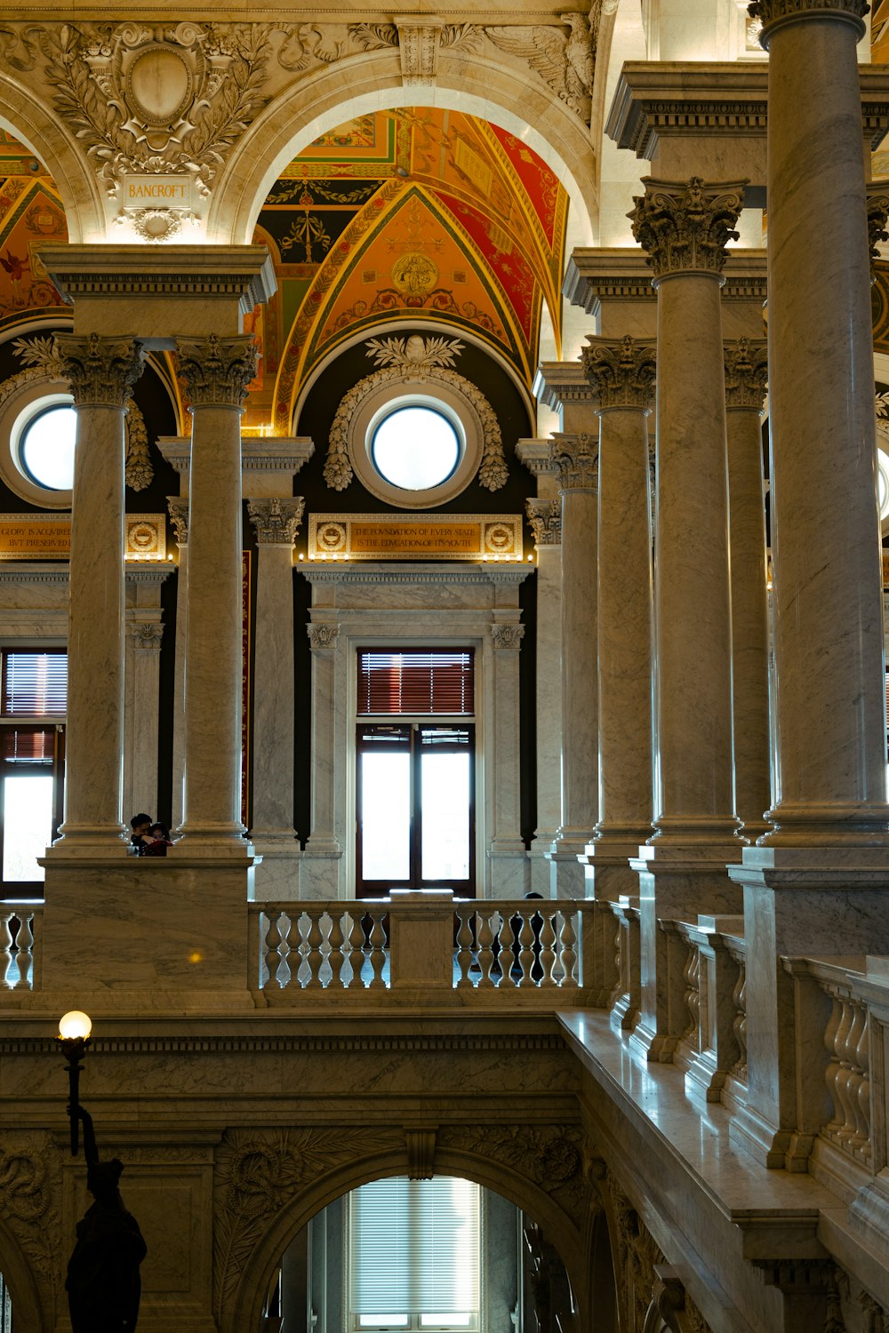 a large building with columns and a clock