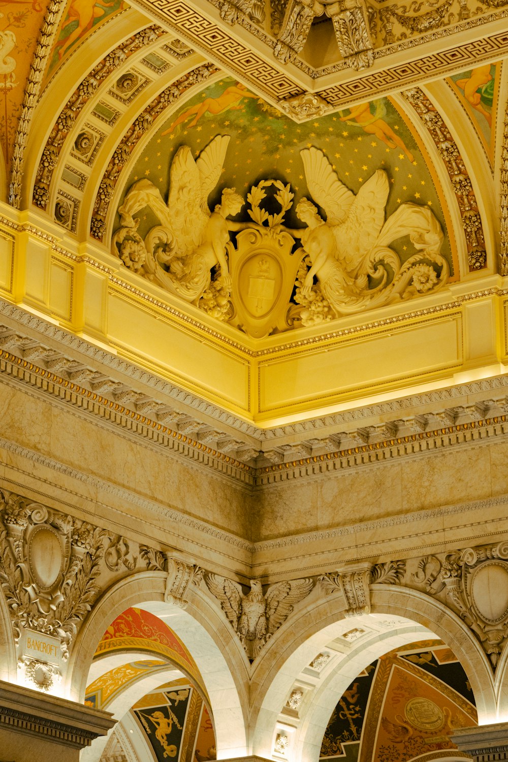 the ceiling of a building with a clock on it