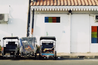 a couple of carts sitting next to a building