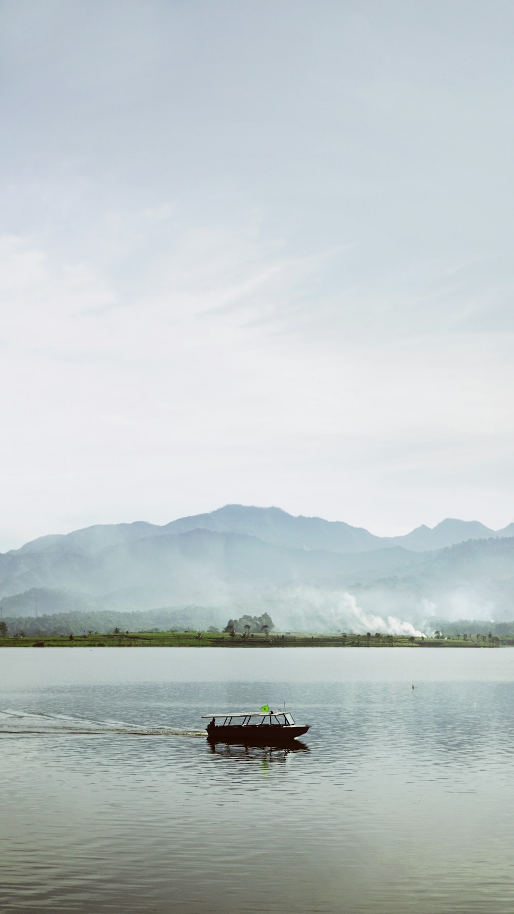 a small boat floating on top of a lake