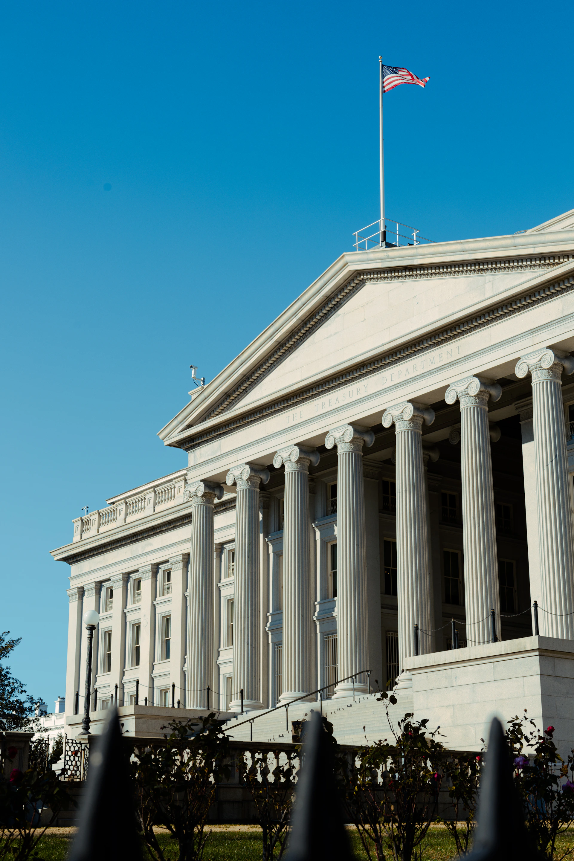 a large white building with a flag on top of it