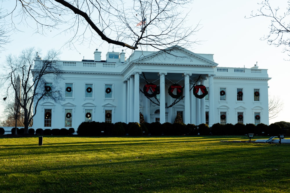 a large white building with wreaths on the front of it