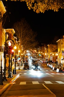 Street lights lining a beautifully lit urban street at night.