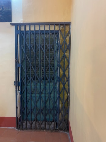 A door gate partially folded to show its flexibility and portability.