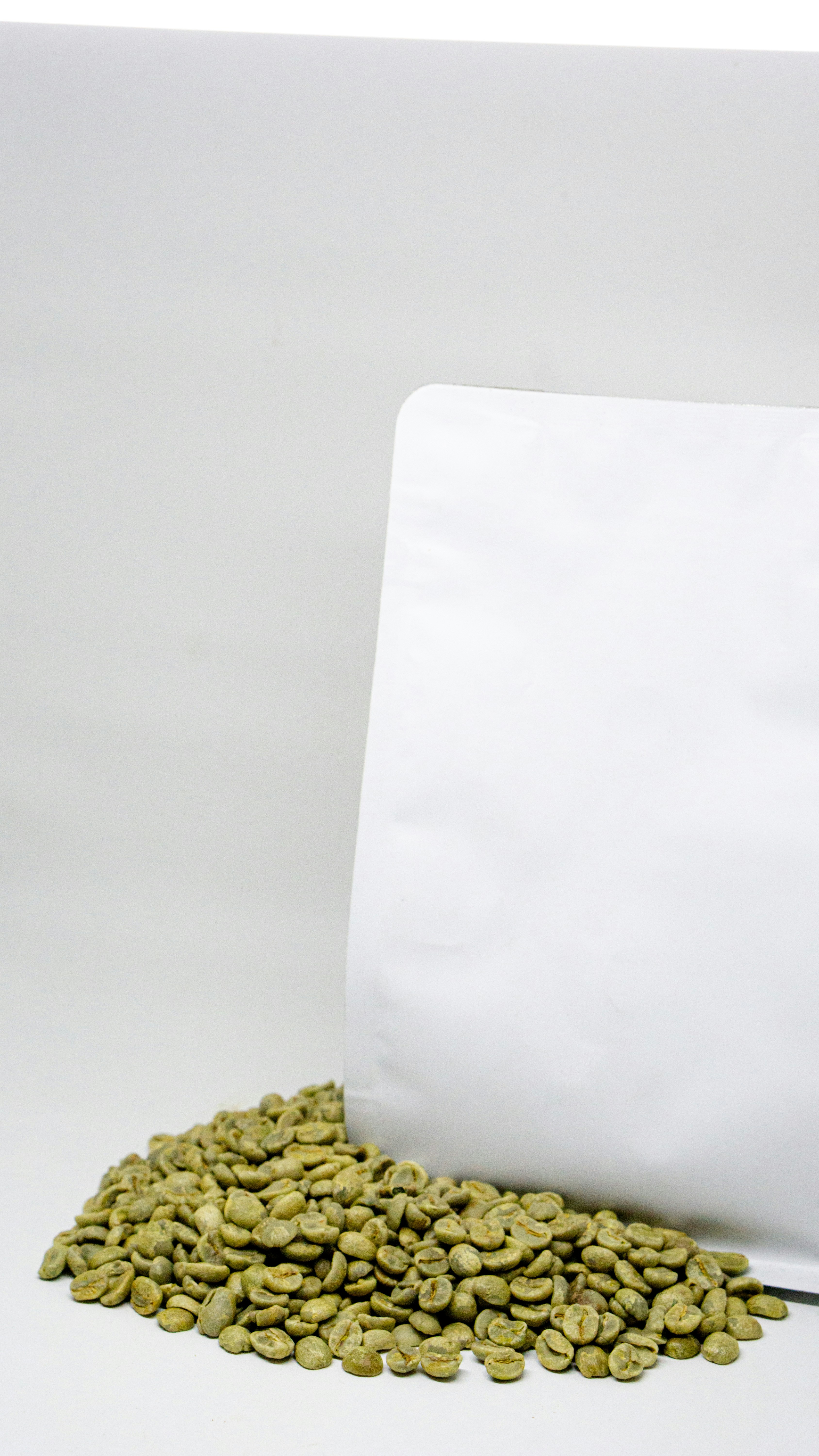 a bag of coffee beans next to a pile of coffee beans