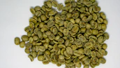 Stacks of carefully sorted green coffee beans ready for export.