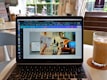 An attractive image of a person working on their laptop, designing marketing materials for real estate with Canva.