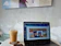 Close-up of a sleek, modern workspace with a laptop showing a creative website design.