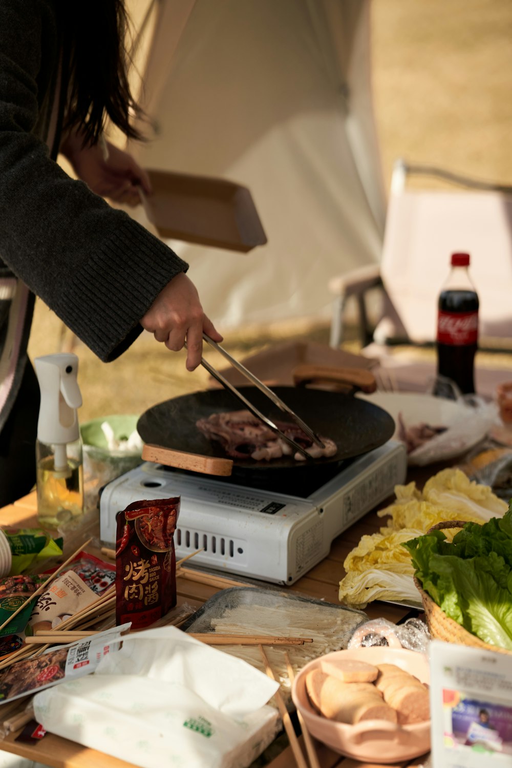 a person is cooking food on a grill